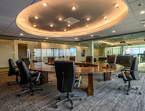 Photo of the office with chairs around a circular table with glass walls.