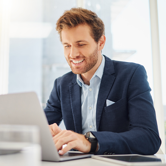 Business professional smiling on laptop
